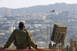 An Israeli soldier is seen next to an Iron Dome rocket …